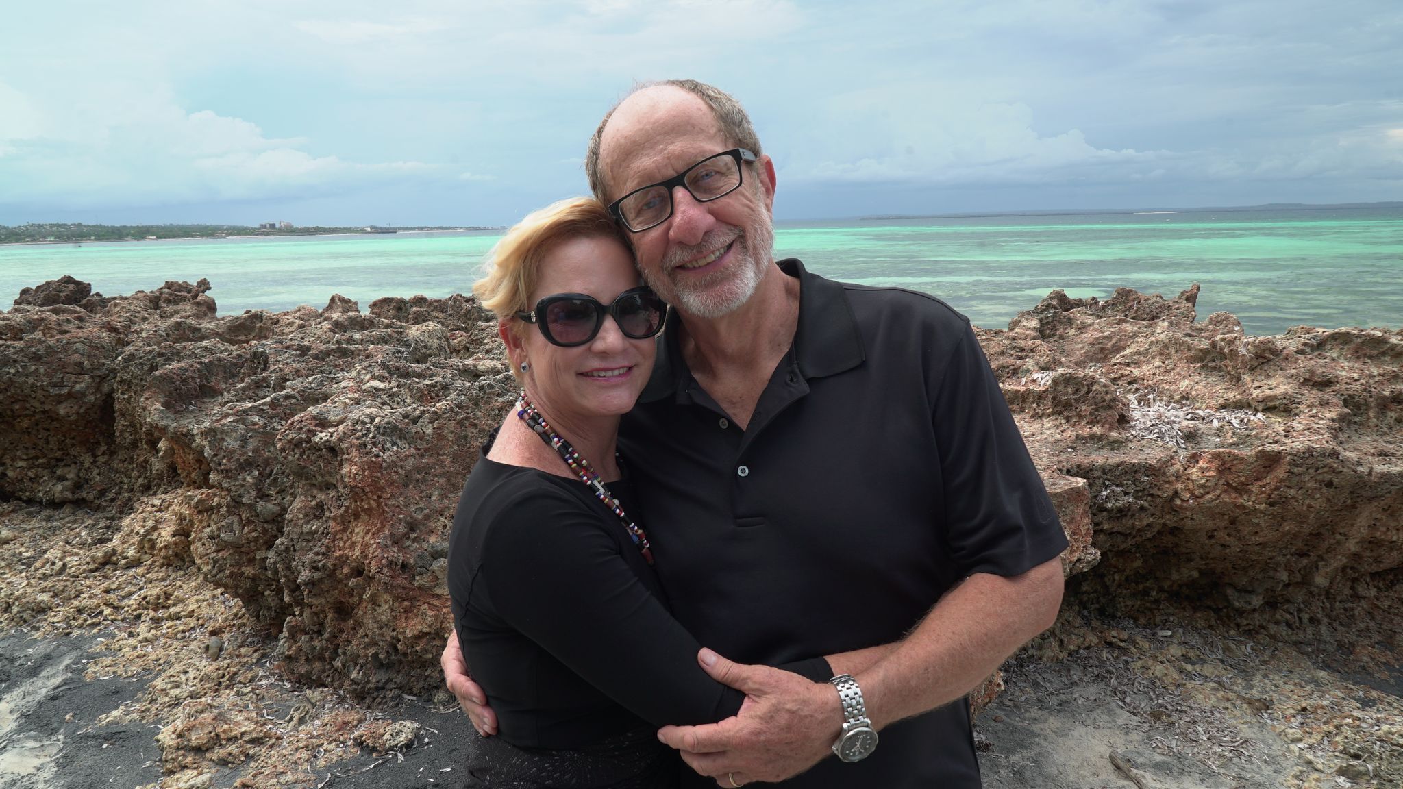 Rolland and Heidi Baker smiling together outdoors by the ocean